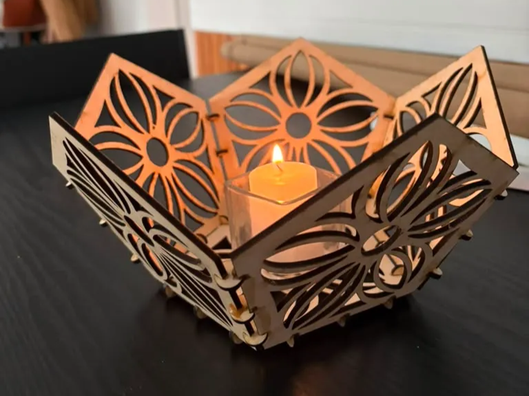 Modular floral cut wooden panels slotted around a lit candle patio lantern idea