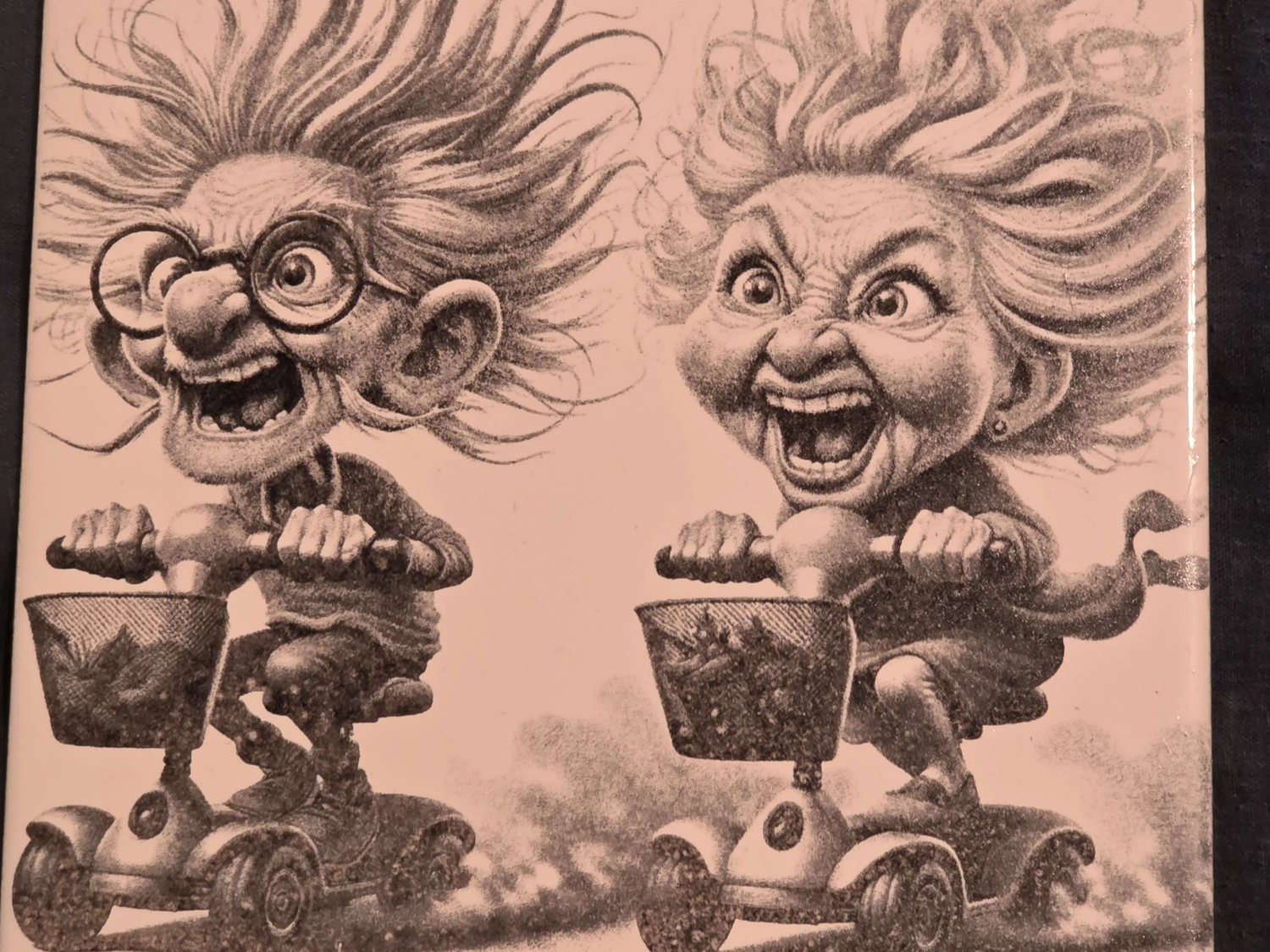 Ceramic tile featuring a humorous illustration of an elderly couple racing mobility scooters