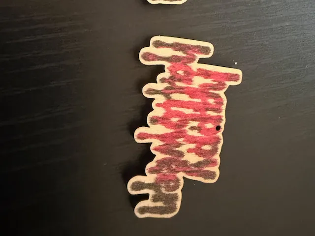 Holzanhänger mit rot-schwarzem Tropf-Muster