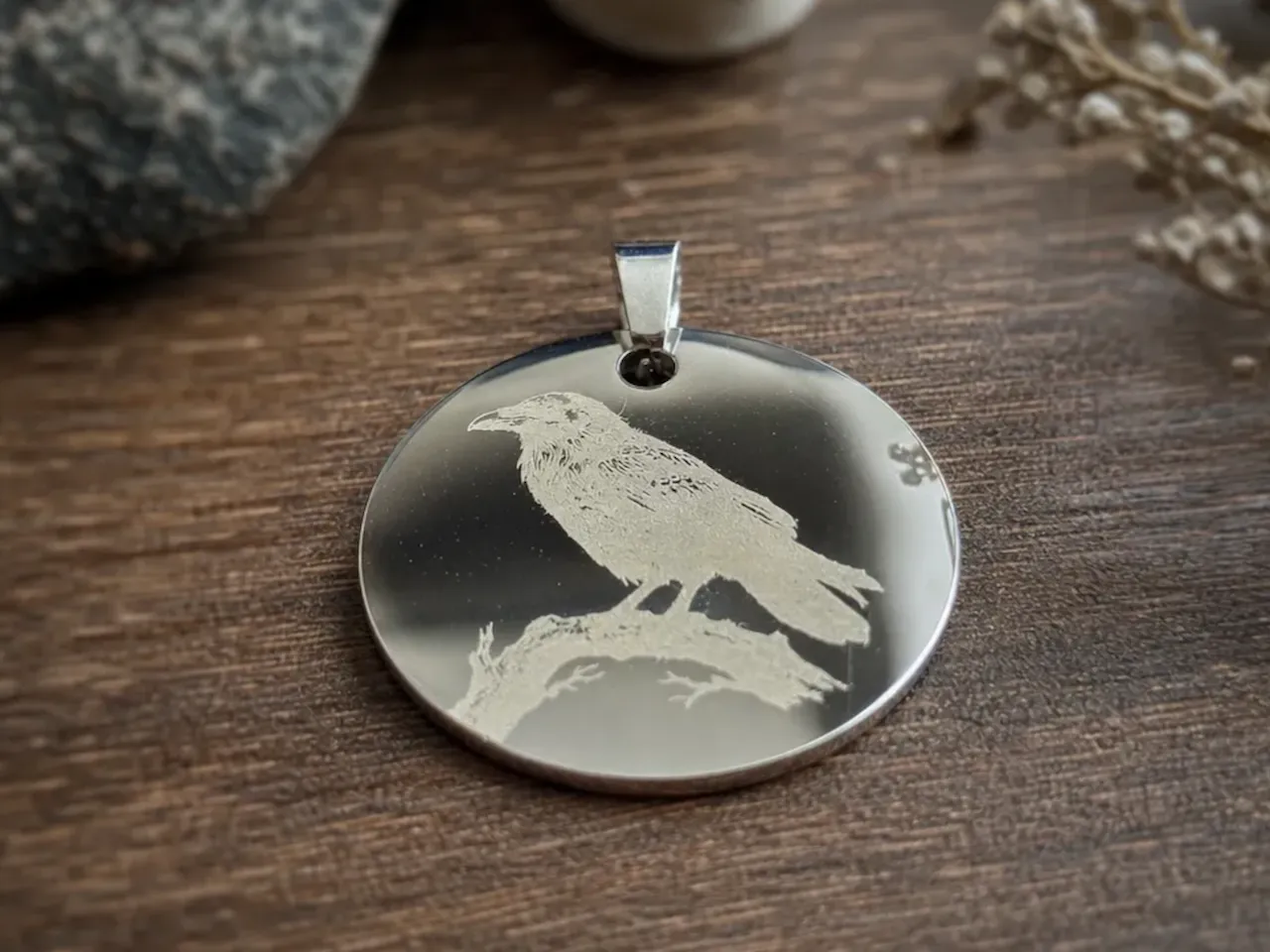 [Laser cut and engrave] Round Silver Pendant Featuring a Detailed Raven on a Branch