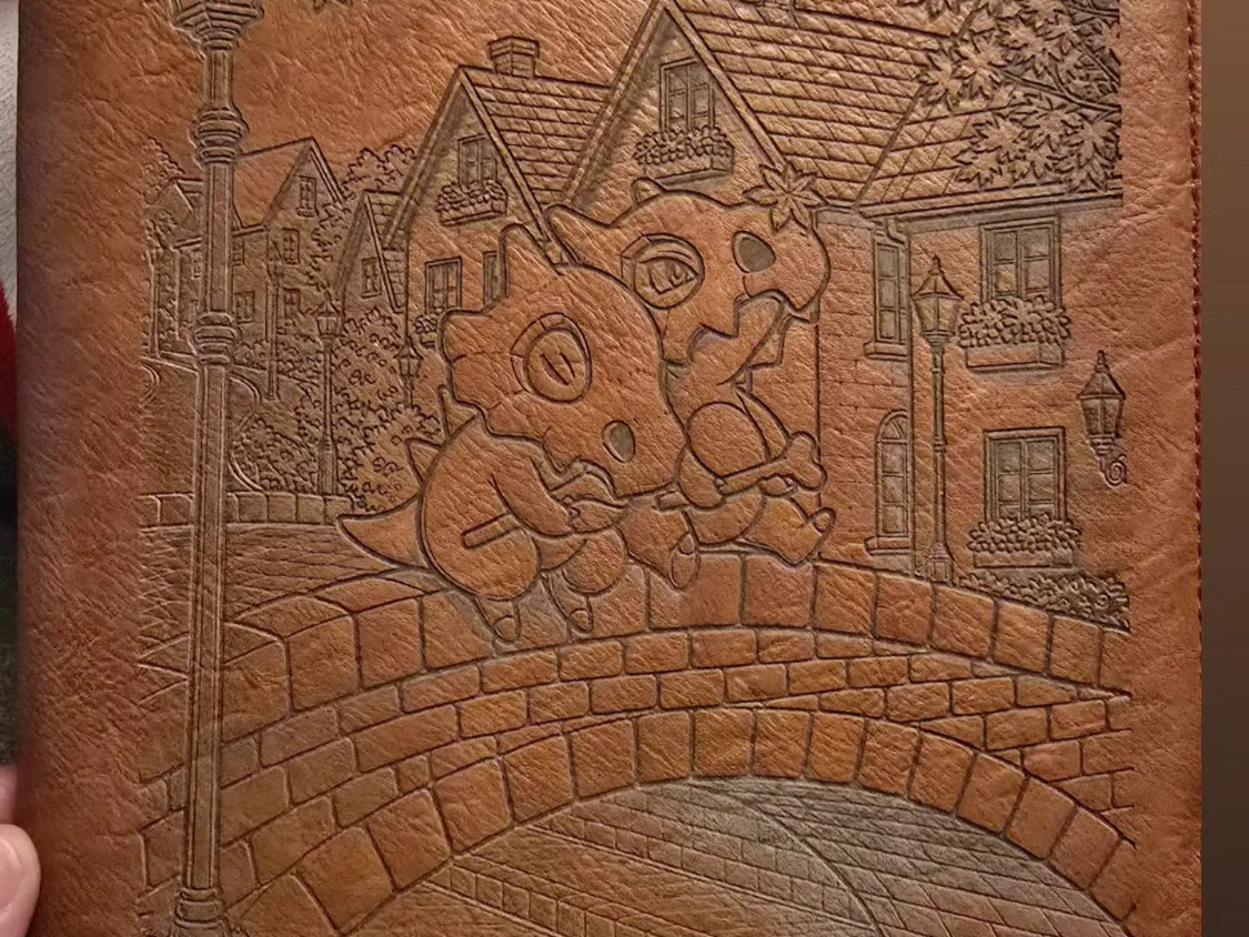 Leather Journal Featuring Cubone Characters in a Village Scene