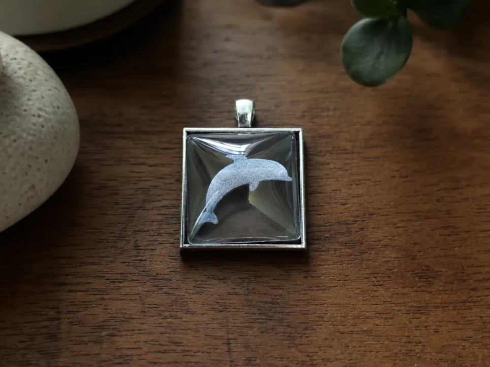 Square Silver Pendant Featuring a Dolphin Silhouette