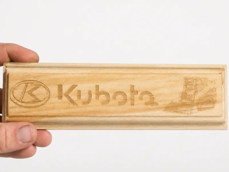Kubota branded wooden sign with track loader