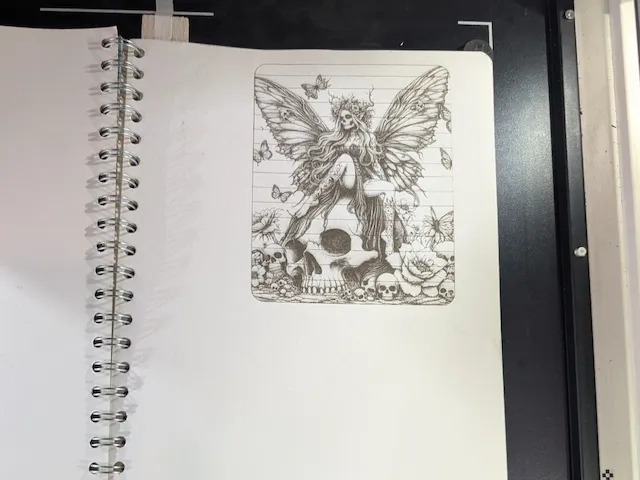 Gothic fairy sitting on a skull with butterflies and flowers illustration