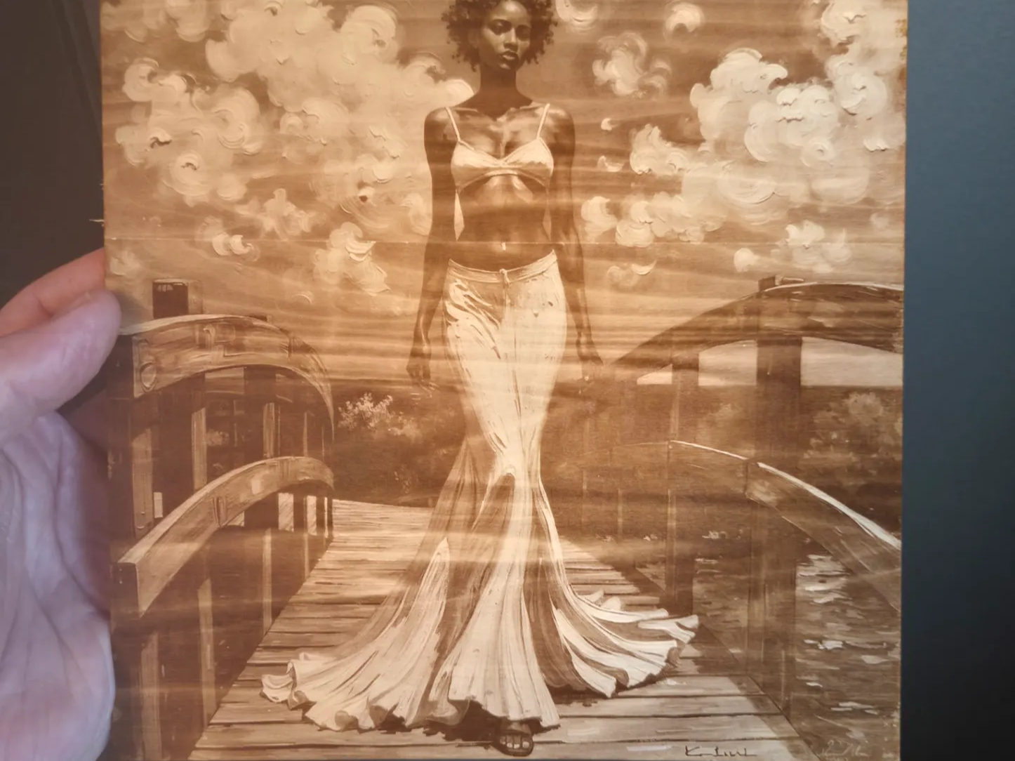 Portrait of a woman in a flowing dress on a wooden bridge