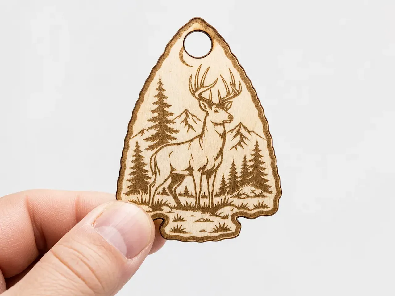 [Laser cut and engrave] Arrowhead Shaped Wooden Ornament Featuring a Deer in a Mountain Forest