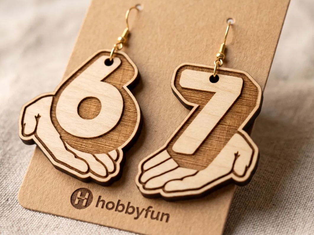 Wooden Number 67 Dangle Earrings Held by Hands