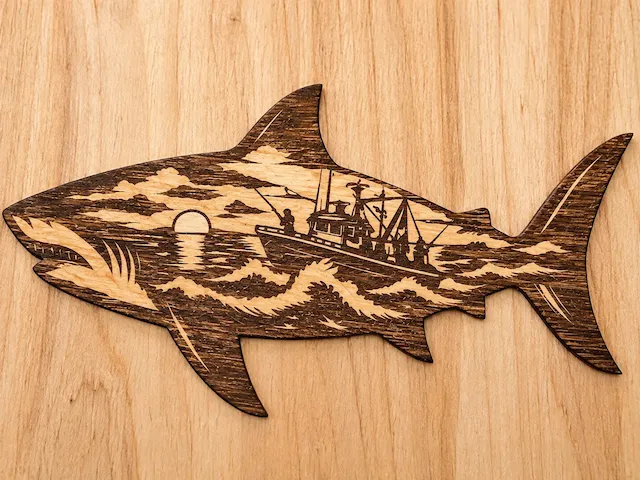 Shark silhouette art featuring a fishing boat at sunset