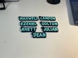 [Laser cut and engrave] Personalized Name Tags with Teal Lettering on Black Background