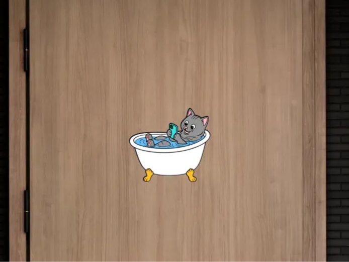 Bathroom door sign. Cat lying in the bathtub.