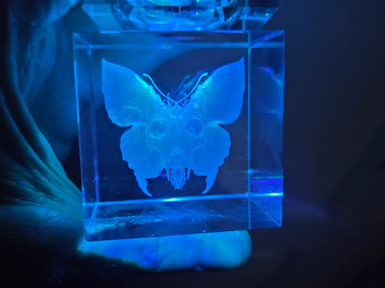 Crystal Cube with Glowing Butterfly and Skull Motif