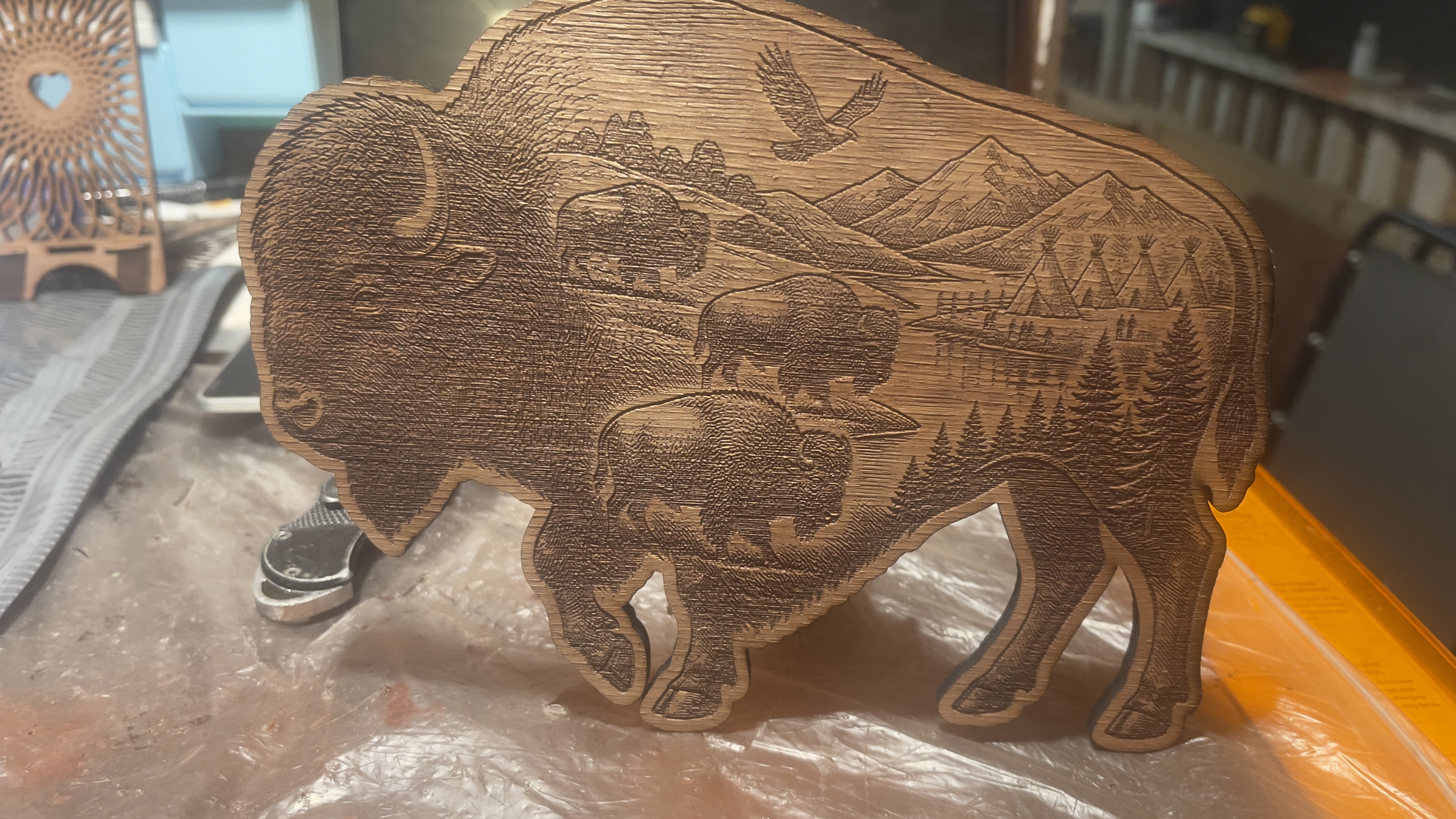 Wooden figure with bison silhouette and mountain landscape instruction: step 1 -