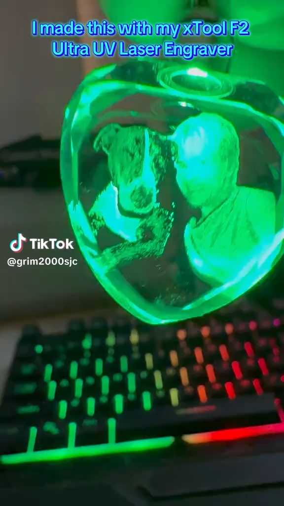 Heart-shaped glass crystal with portrait of person and dog