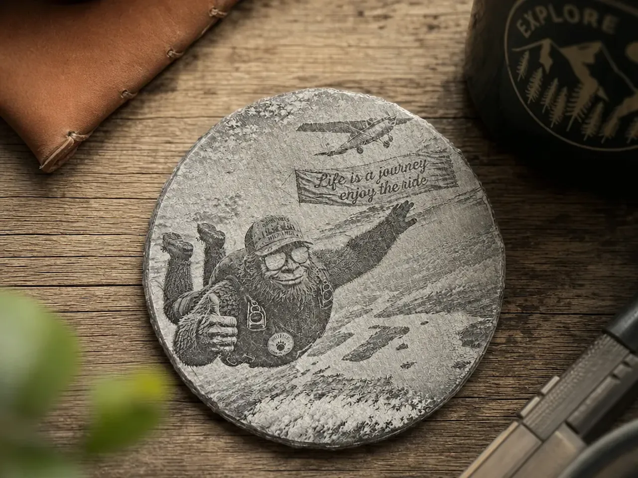 [Laser cut and engrave] Round Slate Coaster Featuring Bigfoot Skydiving with Life is a Journey Quote