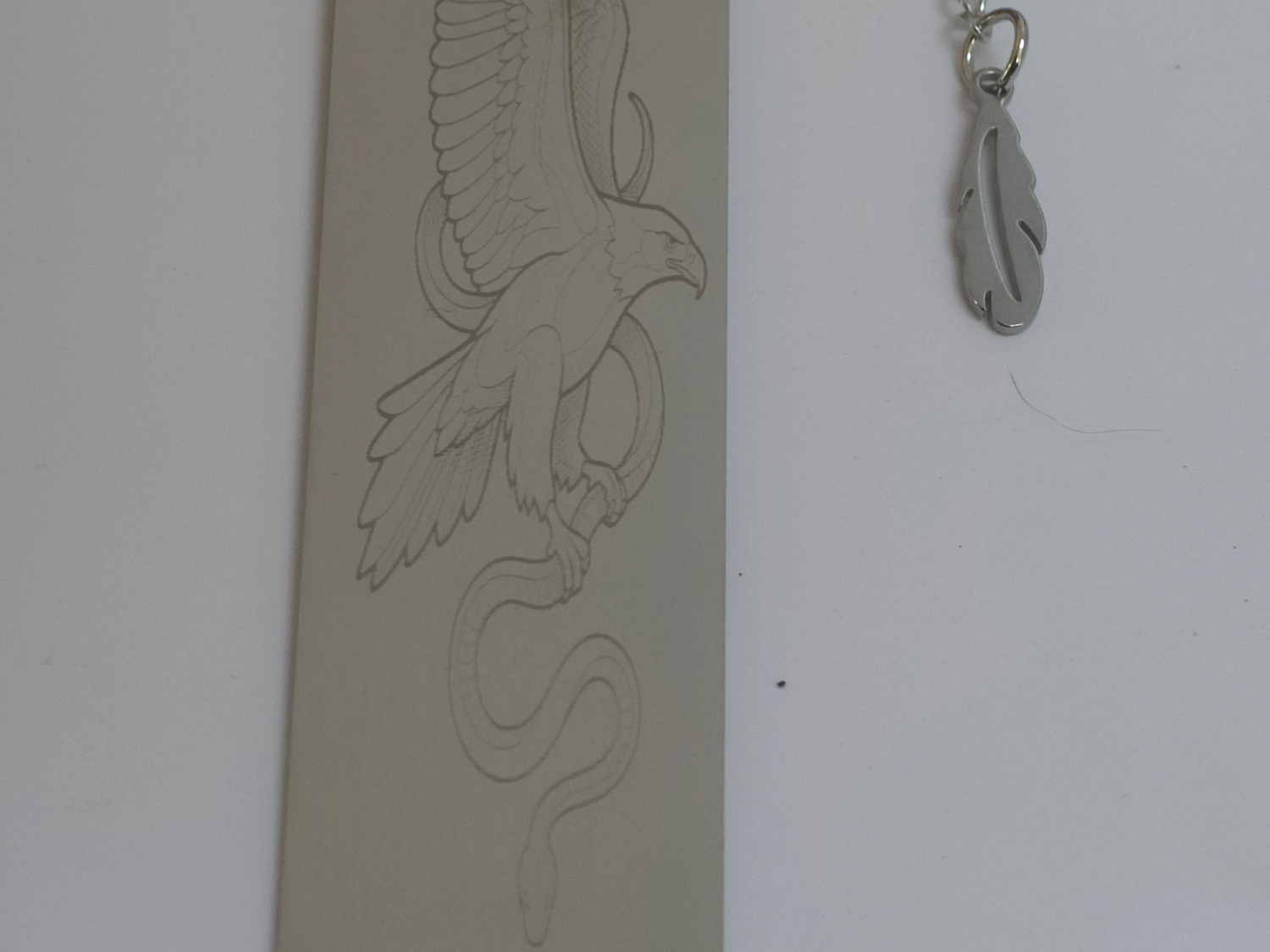 Metal Bookmark Featuring an Eagle and Snake Illustration with Feather Charm