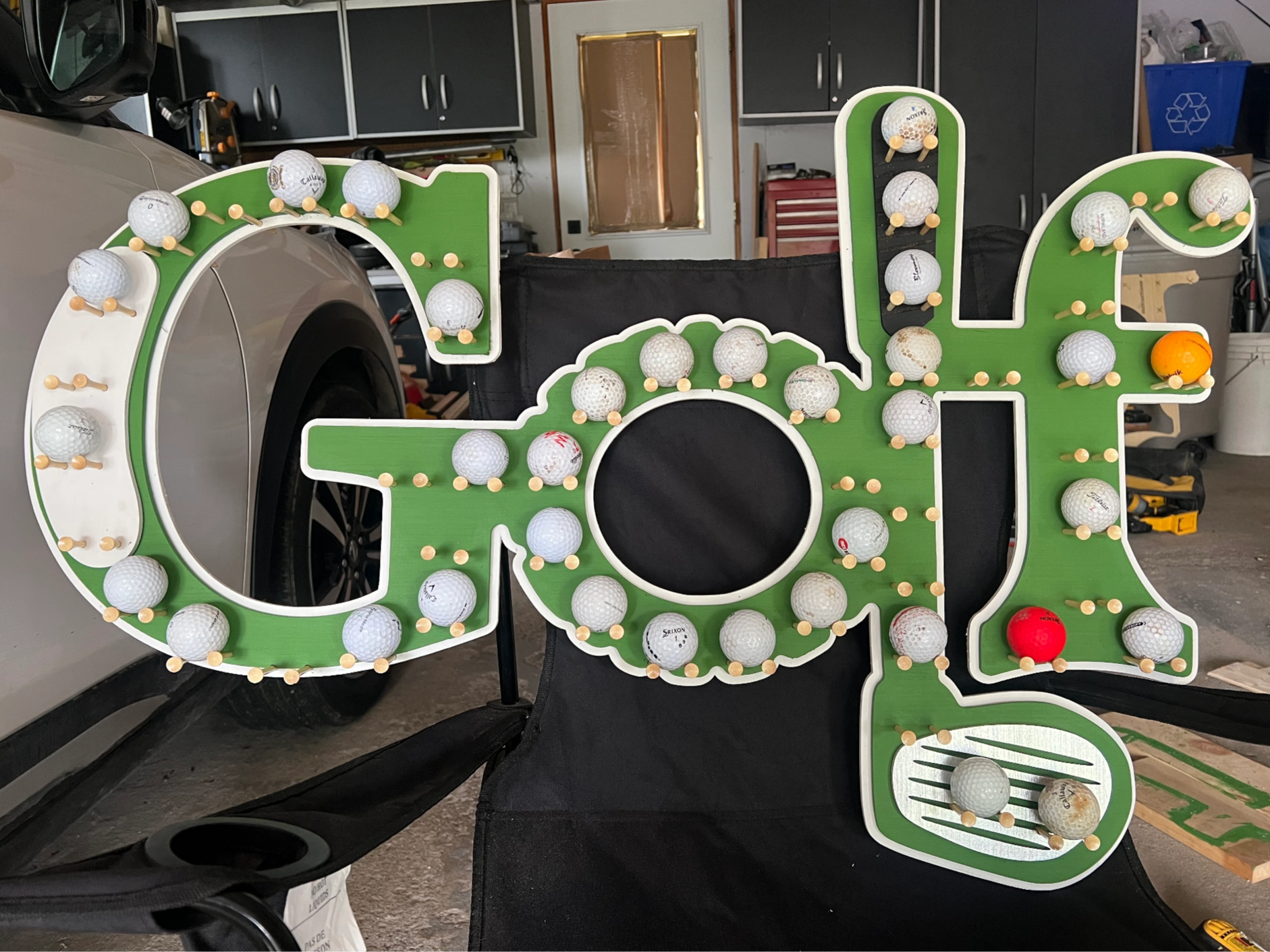 Golf Ball Display Rack Shaped Like Golf Lettering
