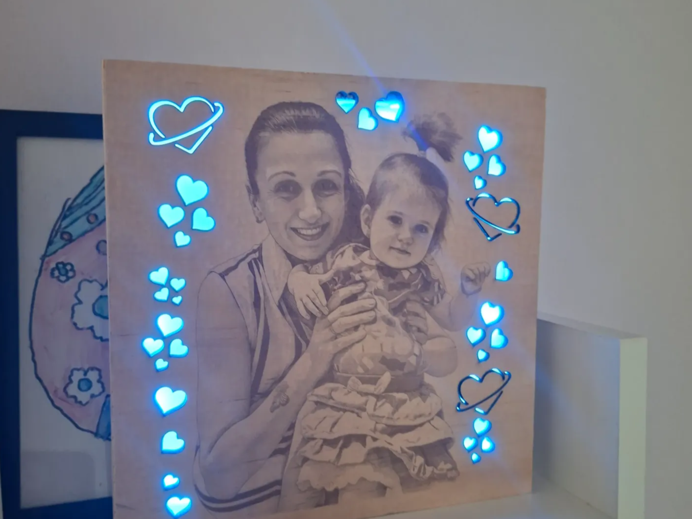 Illuminated wooden portrait plaque with heart cutouts