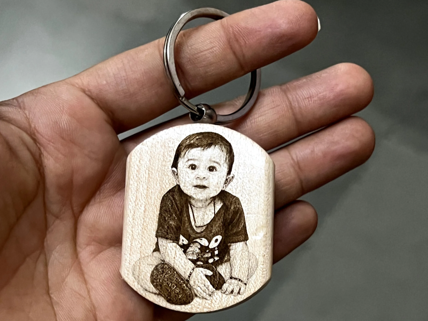Wooden keychain with portrait of a baby