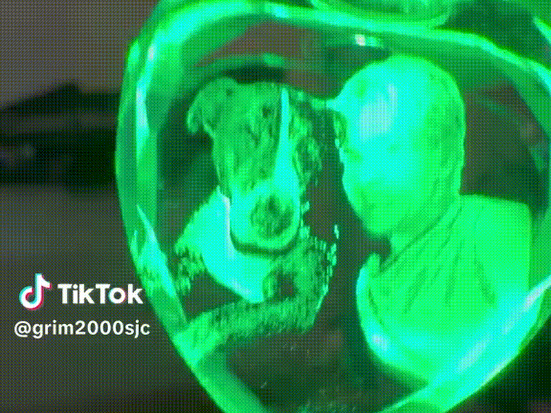 Heart-shaped glass crystal with portrait of person and dog
