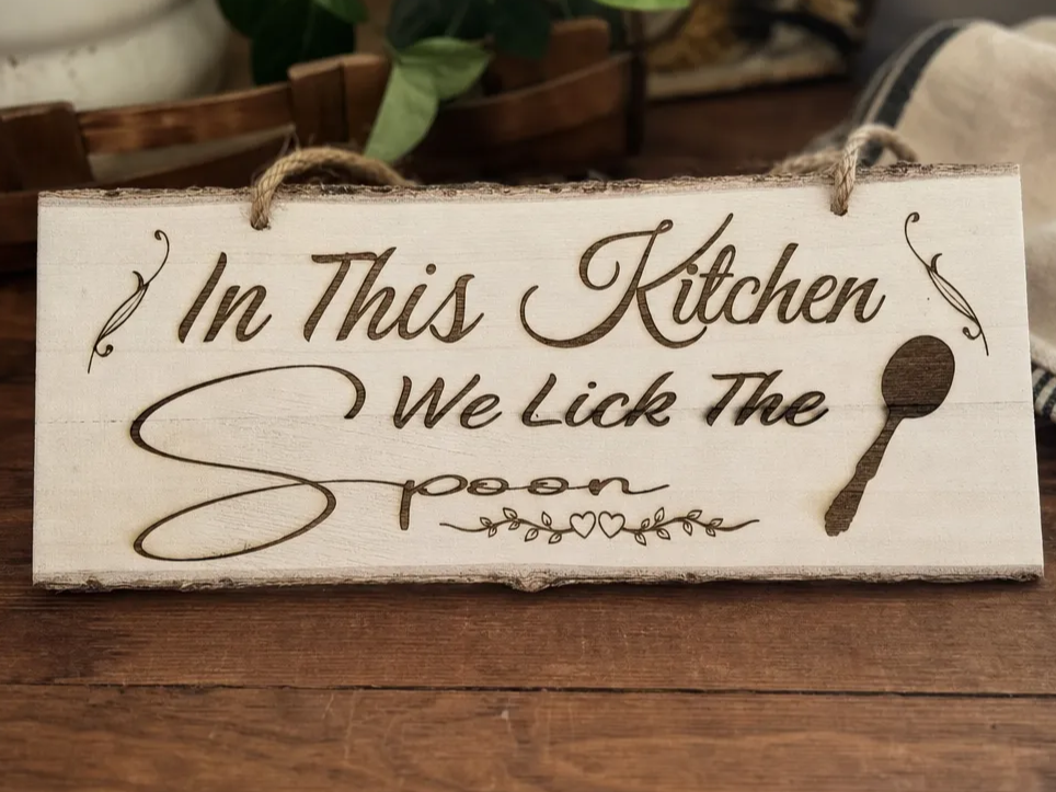 In This Kitchen We Lick The Spoon Hanging Wood Sign