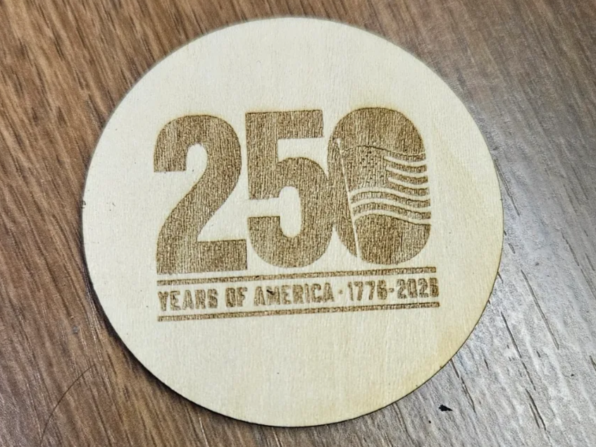 Double sided wooden coin commemorating USA 250
