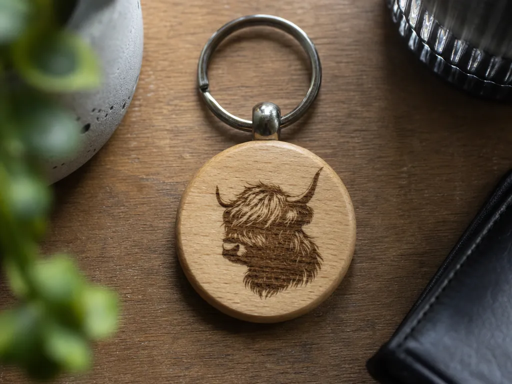 Round Wooden Keychain Featuring a Highland Cow Illustration