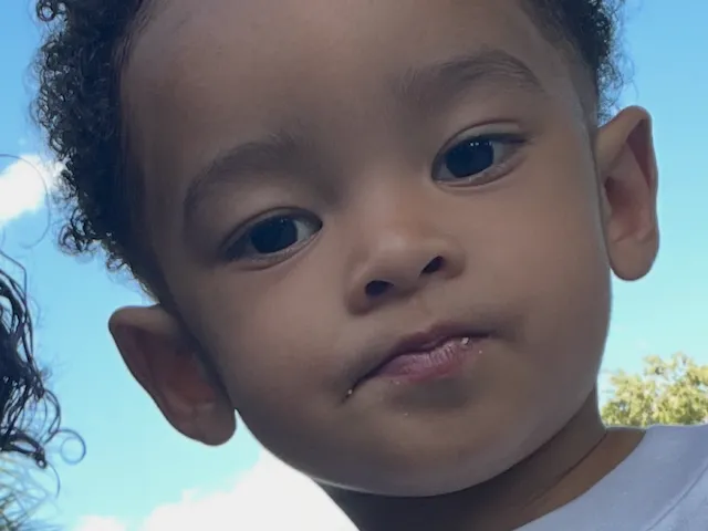Close-up portrait of a young toddler with curly hair