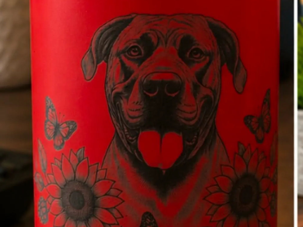 Pink tumbler featuring a dog portrait with sunflowers and butterflies