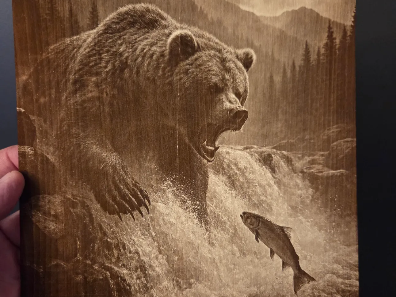 Grizzly bear catching a salmon in a mountain waterfall wall art