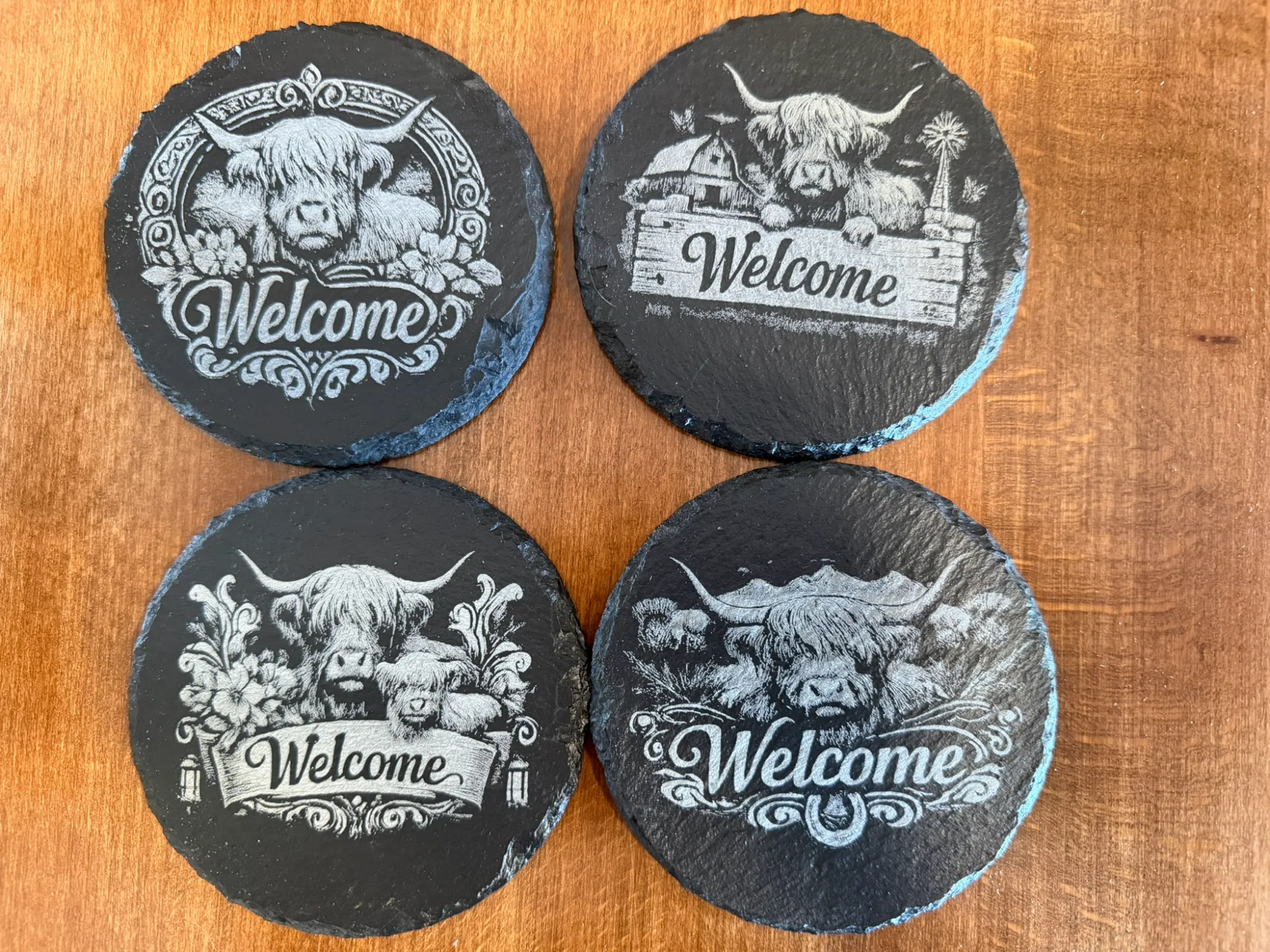 4 Pack of Round Slate Coasters Featuring Highland Cow Welcome Designs
