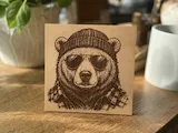 [Laser cut and engrave] Wooden sign featuring a cool bear wearing a beanie and sunglasses
