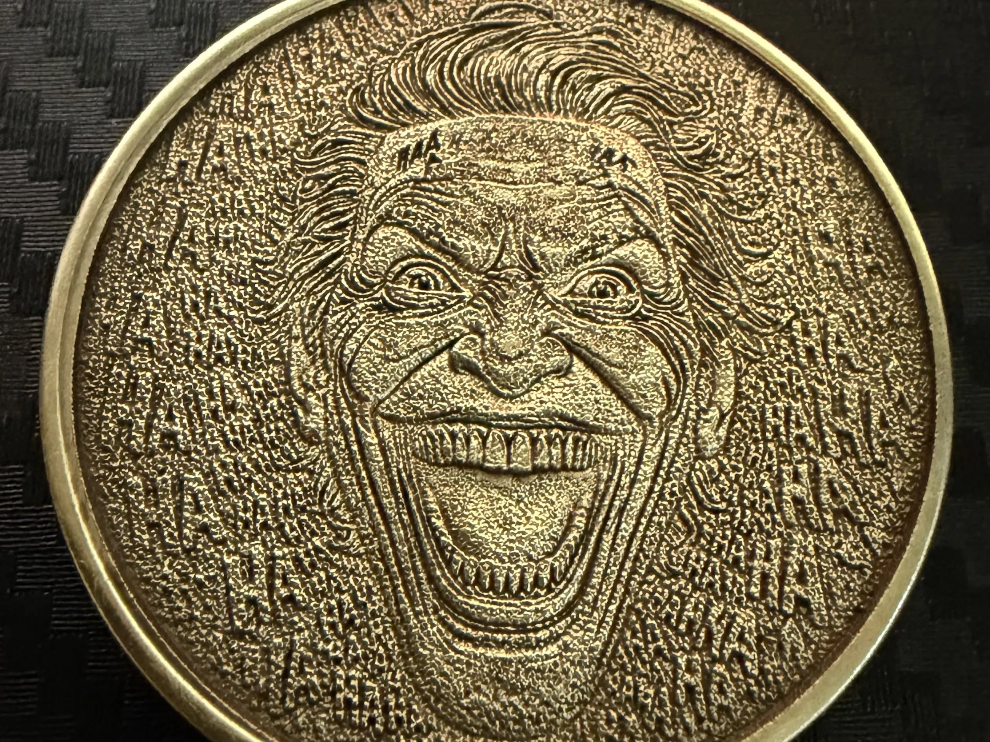 The Joker gold coin with laughing HAHA text pattern