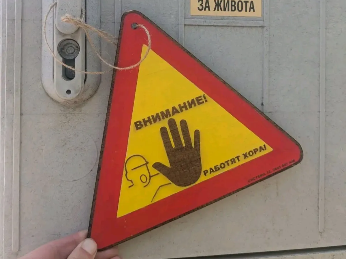 Triangular Warning Sign with Stop Hand Symbol