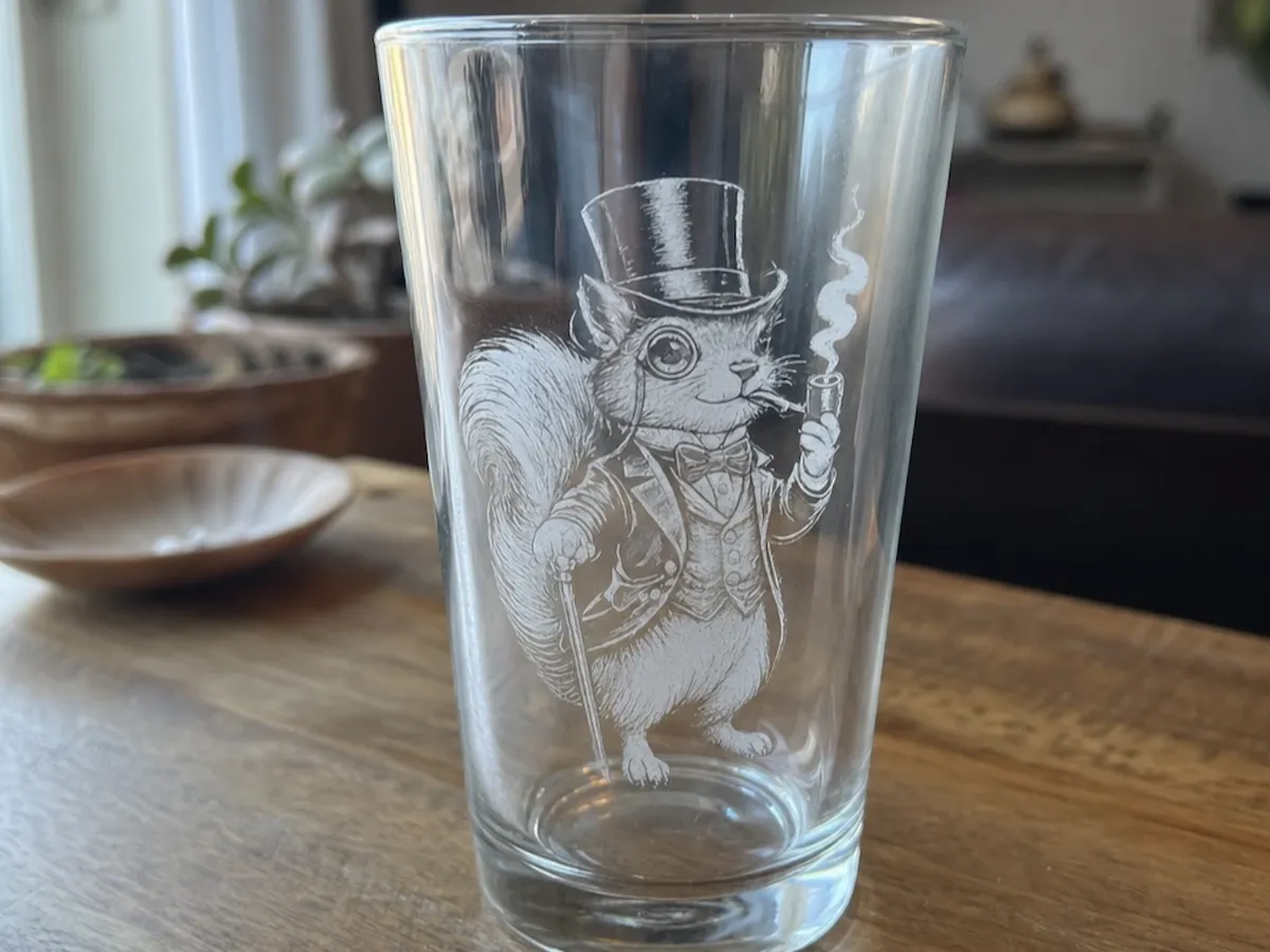 [Laser cut and engrave] Pint glass featuring a dapper squirrel in a top hat and tuxedo