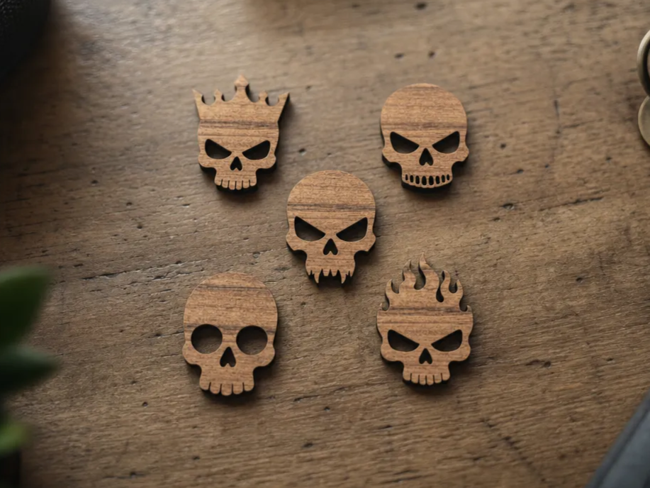 Set of Five Wooden Skull Embellishments with Crown and Flame Motifs