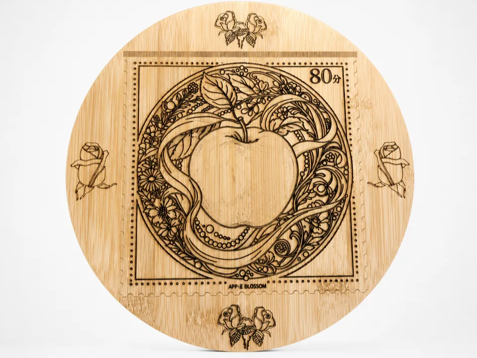 Round wooden serving board with apple blossom postage stamp illustration
