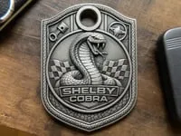 [Laser cut and engrave] Shelby Cobra Metal Keychain Tag with Racing Flag and Piston Motif