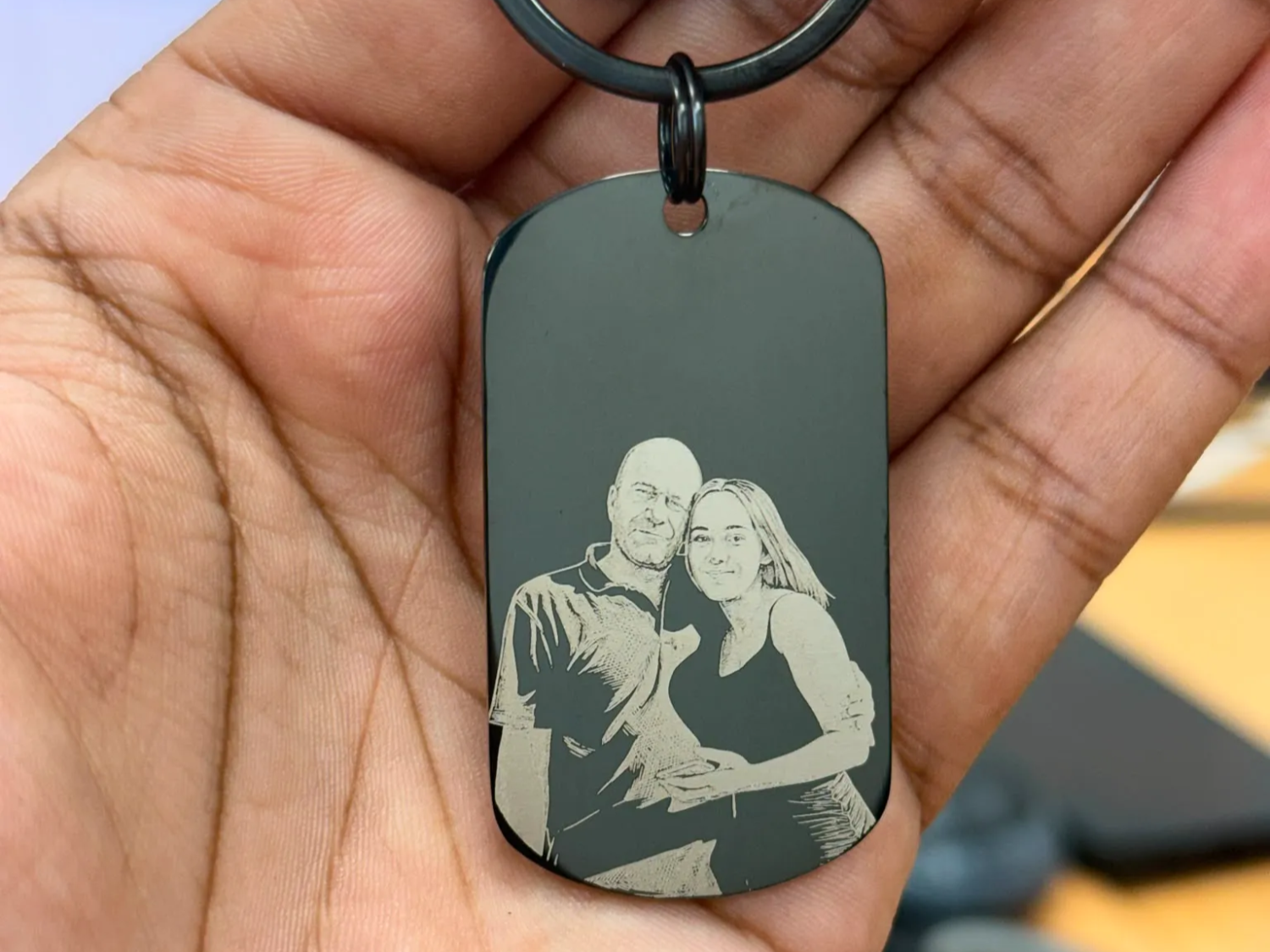 Black metal dog tag keychain with portrait of a couple
