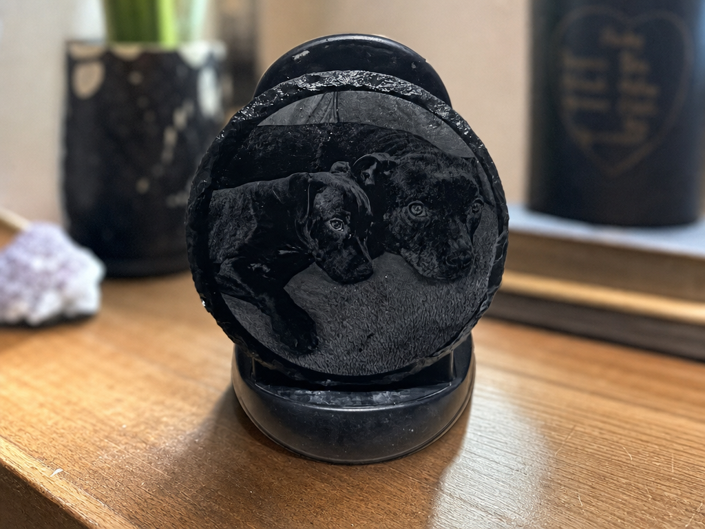 Round slate coaster featuring a portrait of two dogs