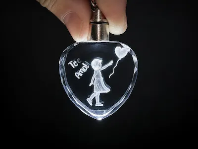 Heart-Shaped Crystal Keychain with Girl and Balloon Illustration