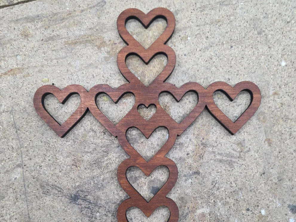 Heart cross made of hearts with center heart